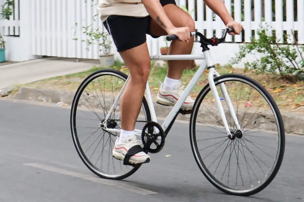 Image of a cyclist riding a fixie bike. Source: Unsplash