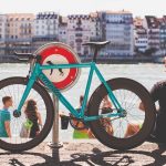 Man sitting by river with fixed gear bike. Source: Unsplash
