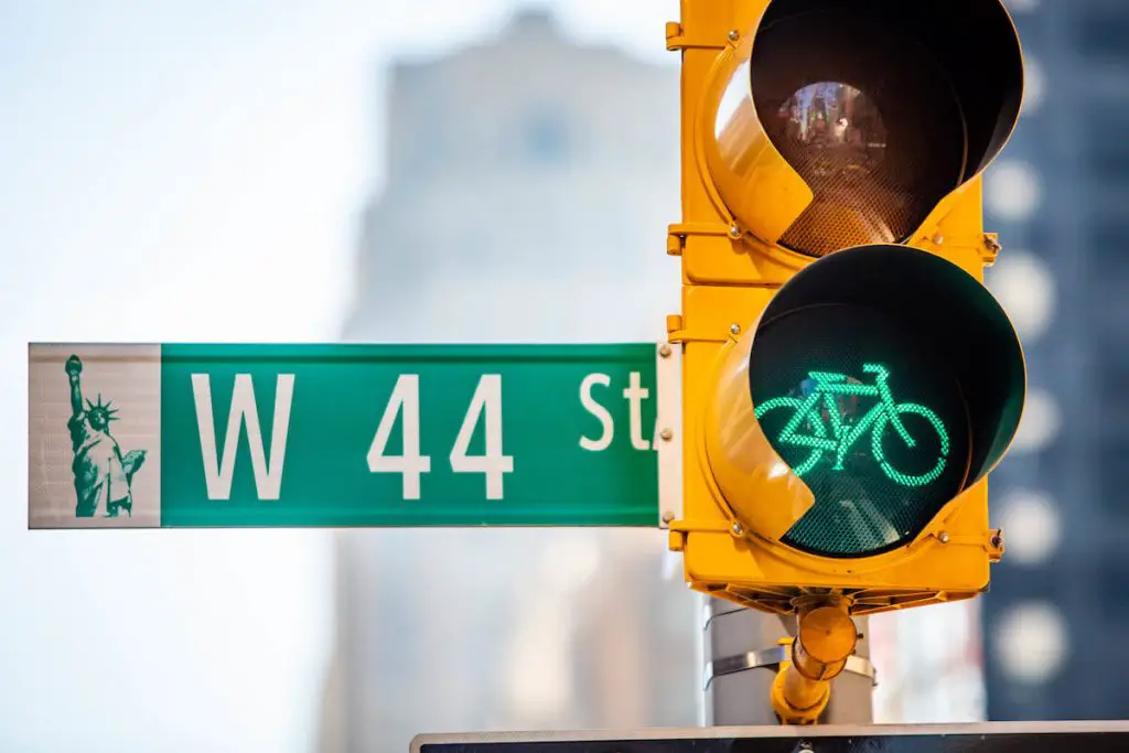 Green bicycle traffic light on 44th street, signifying new york bike laws.