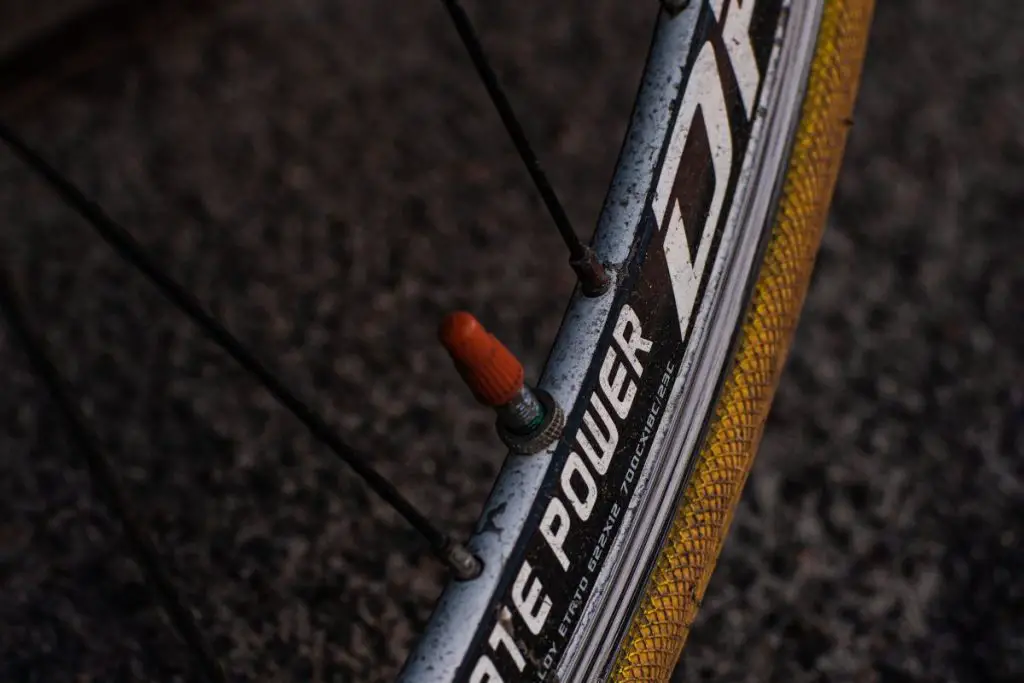 Image of bicycle tire with a red valve. Source: Unsplash