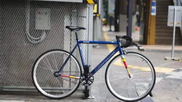 Blue Tsunami SNM100 single speed bike with drop bars on city streets. Source: Arif Maulana, Unsplash