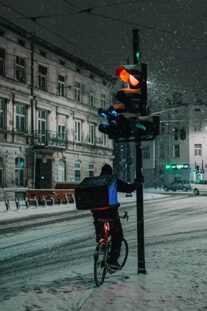 Cyclist riding in slushy winter snow