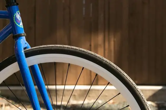Blue fixed gear bike with no front brakes.