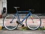 Blue Tsunami Snm100 Single Speed Bike With Drop Bars And Pedal Straps On City Streets. Source: Arif Maulana, Unsplash