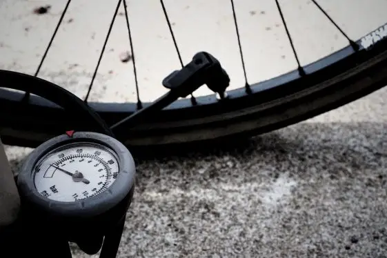 Bike tire getting inflated with gauged air pump.