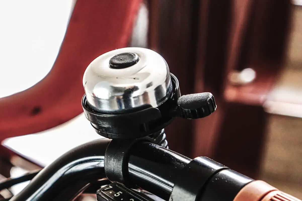 Image of silver bicycle bell on a bike handlebar. Source: kwon junho, unsplash