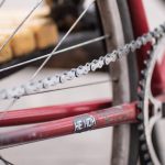 Image of a red bicycle with a silver chain. Source: 선인장, Unsplash