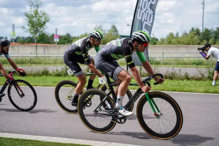 Three high performance cyclists in a track race competition with a fixed gear bike. Source: Yomex Owo, Unsplash