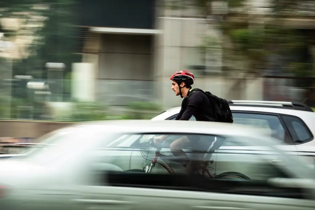 Image of a cyclist commuting in the city traffic.