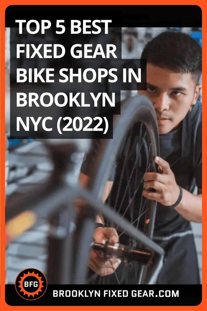 Image of a man with an apron repairing a bicycle in bike shop. Pinterest