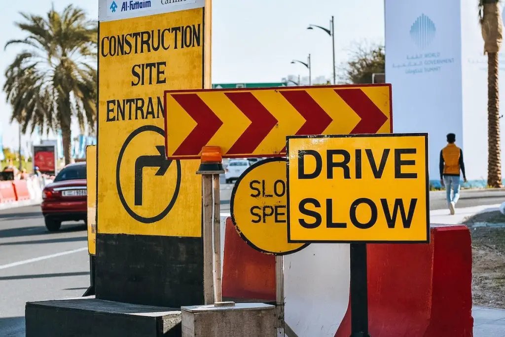 Image of many traffic signs in street. Source: tim gouw, pexels