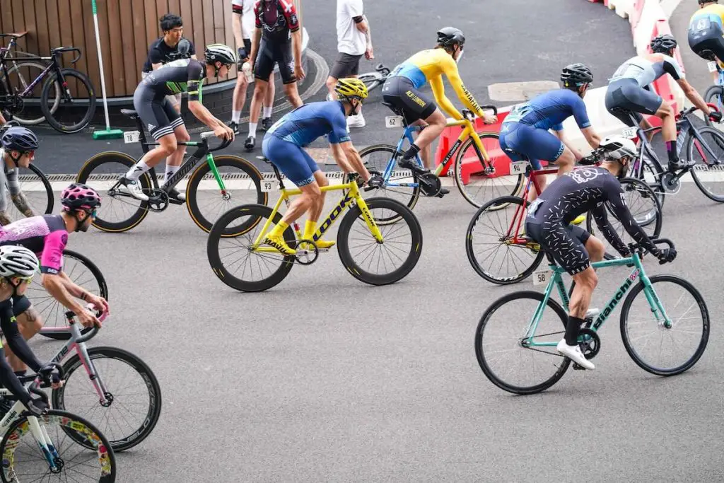 Track bike cyclists at an outdoor crit competition. Source: yomex owo, unsplash
