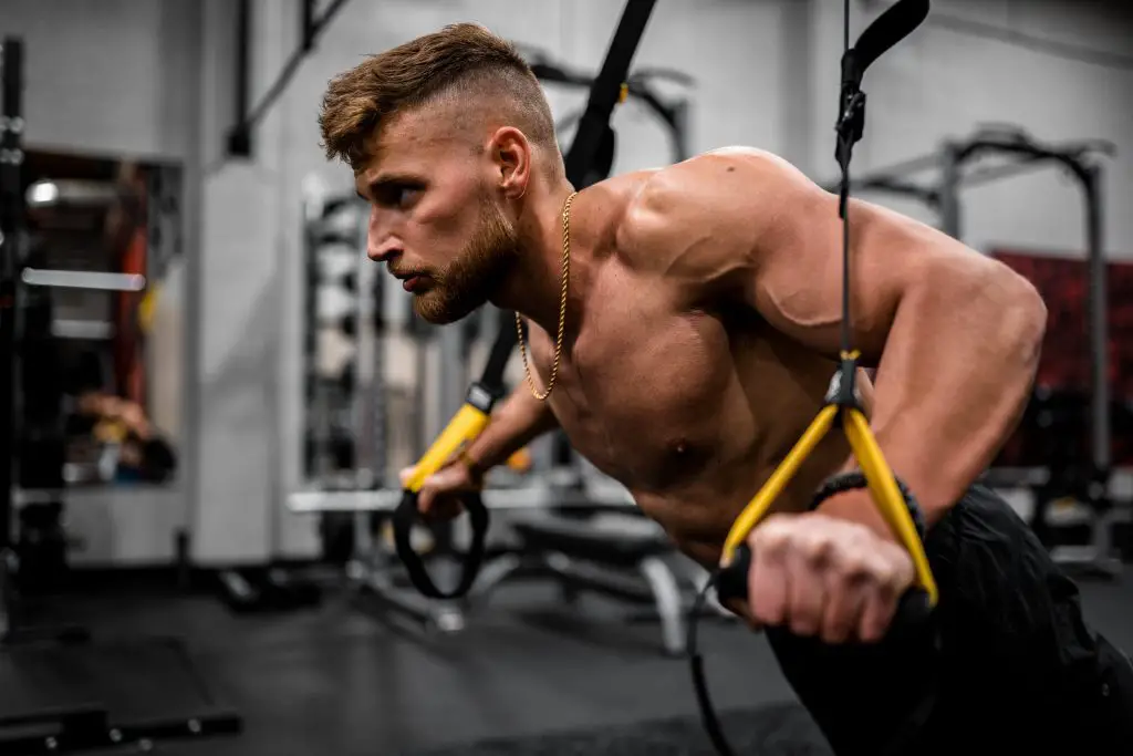 Image of a man working out at the gym. Source: anastase maragos, unsplash