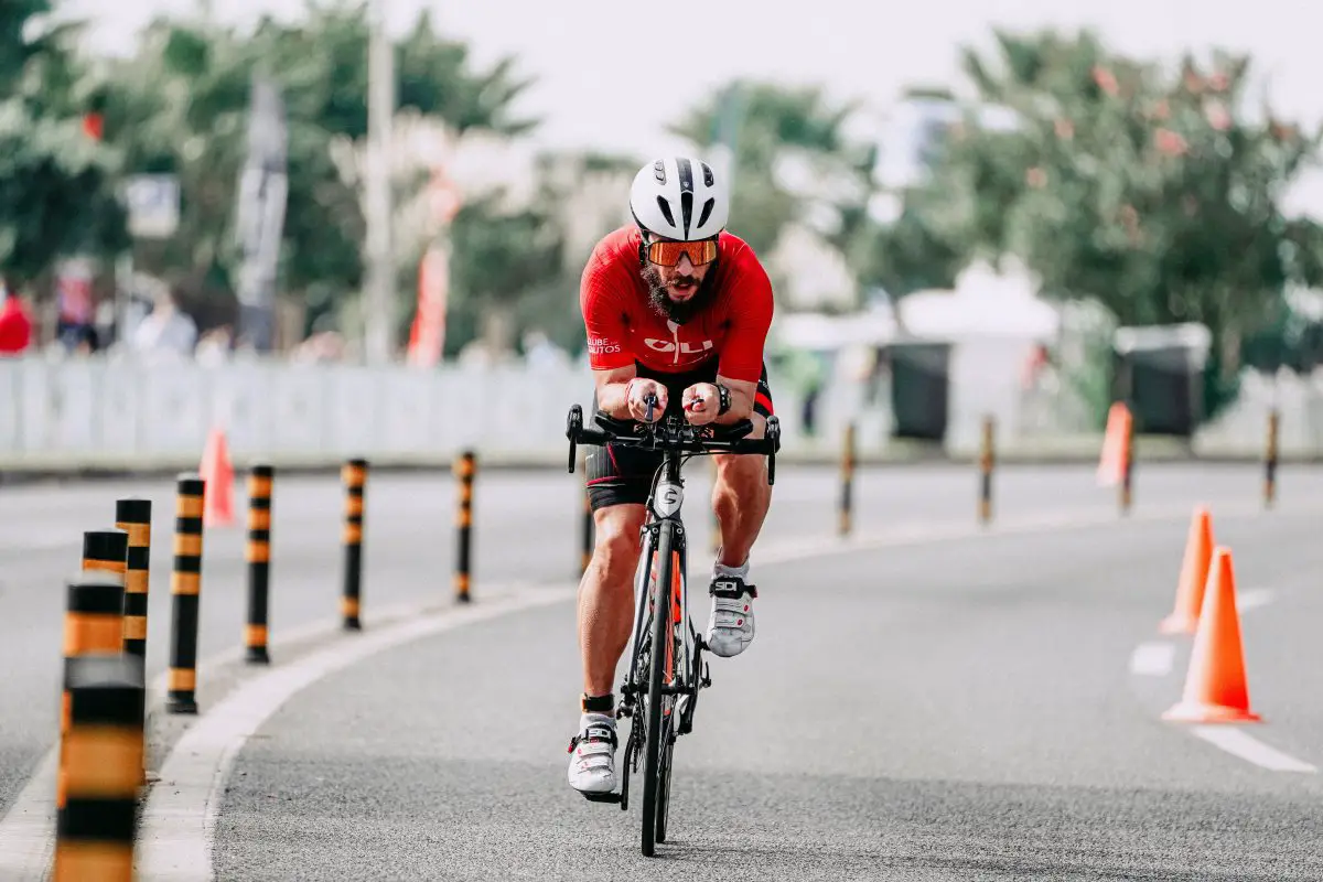 Image of male cyclist in red jersey practicing on the track. Source: pexels