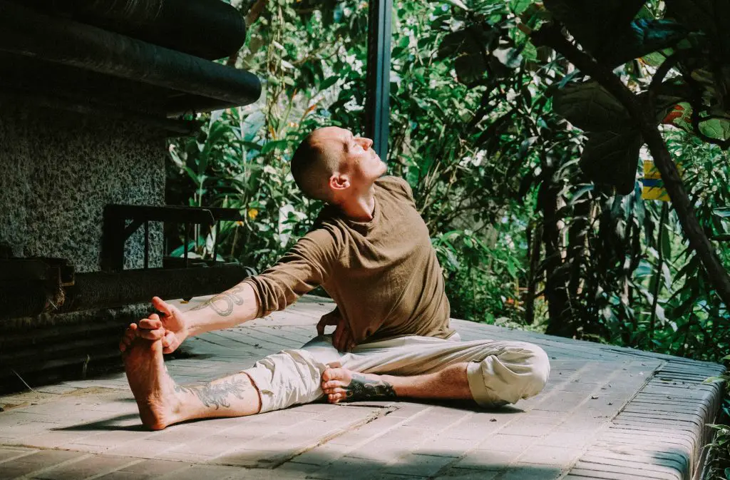 Image of man practicing yoga. Source: benn mcguinness, unsplash
