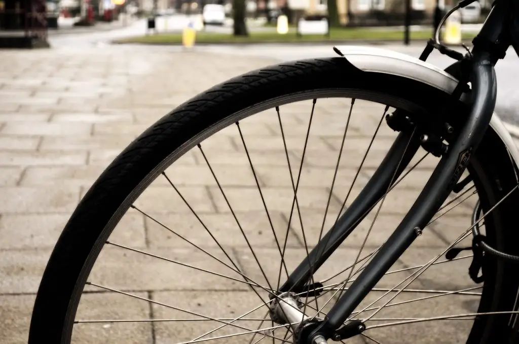 Image of a bicycle's front wheel with bike fender. Source: spokes, pixabay