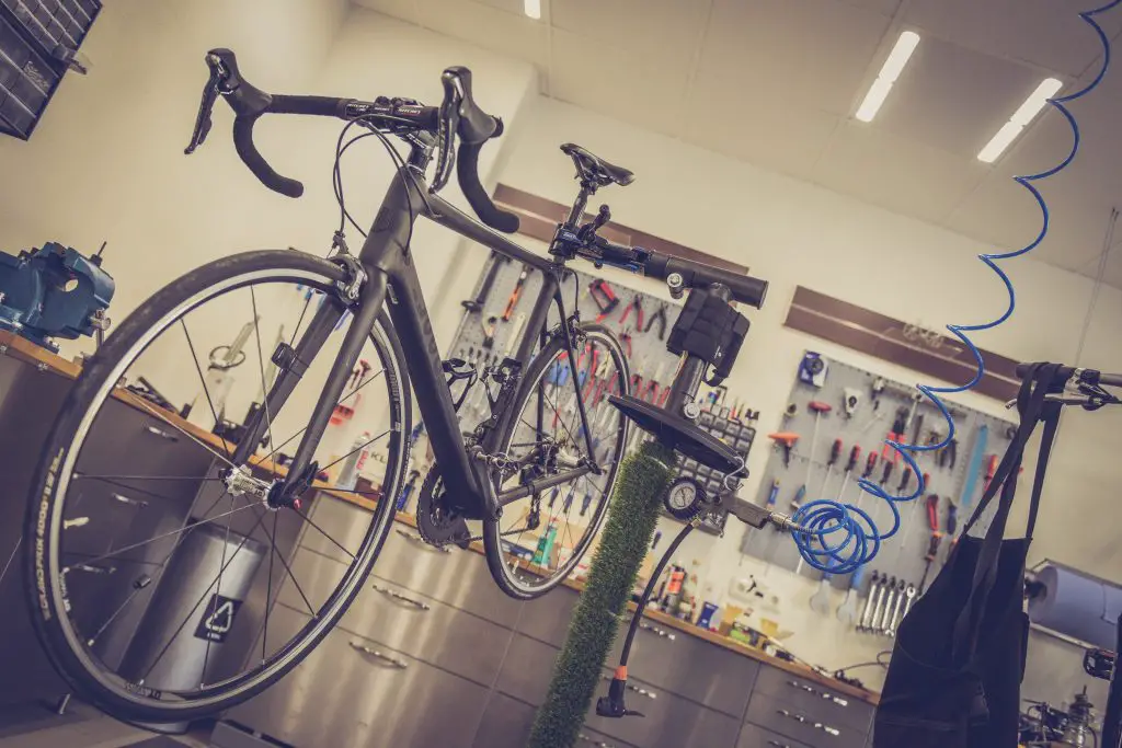 Image of a bike in a bicycle repair stand. Source: alexander dummer, pexels
