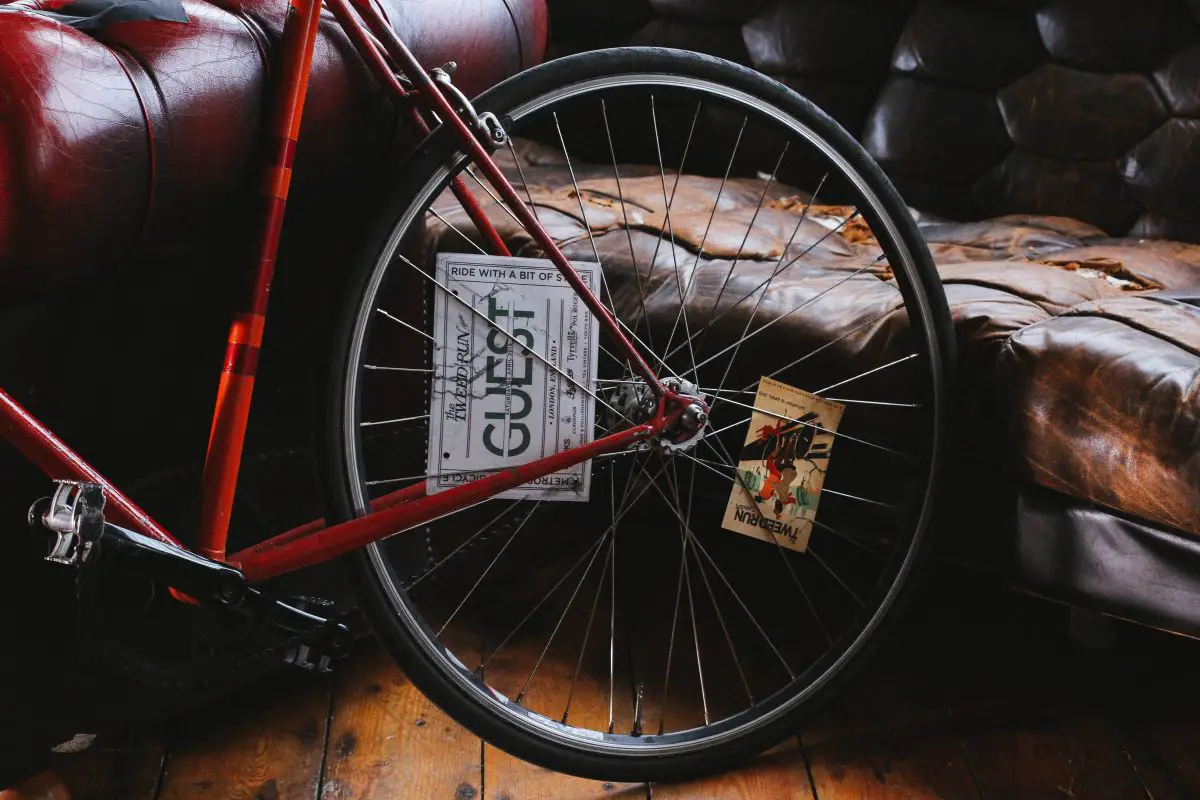 Image of a red frame and bike wheel of a fixie. Source: yulia chinato, unsplash