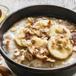Image of a bowl of breakfast oatmeal and bananas. Source: Adobe Stock