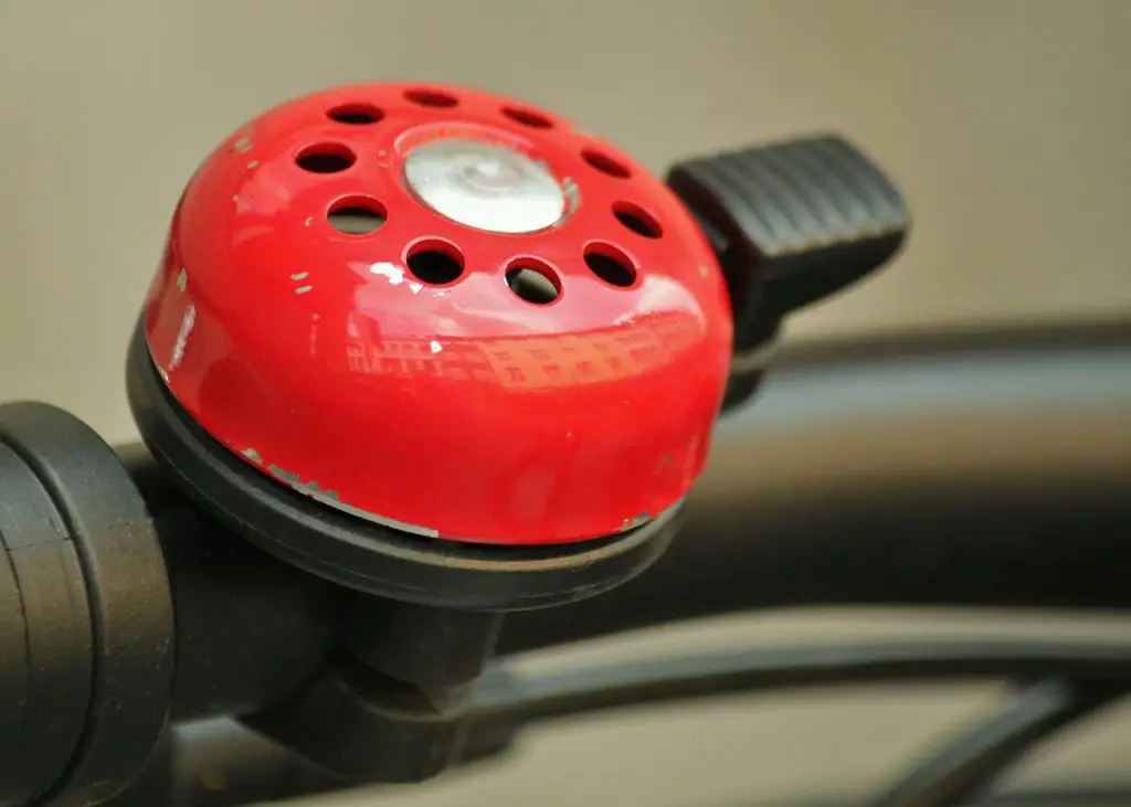 Image of a red bicycle bell attached to a bike source pixabay