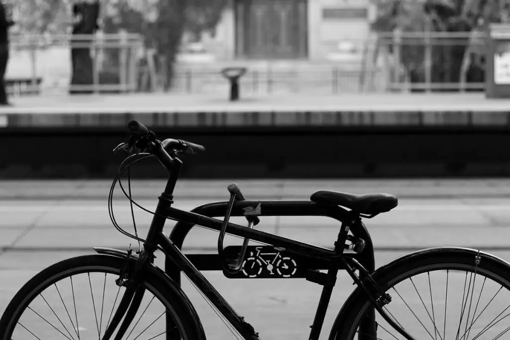 Image of a bike locked to a metal fence. Source: unsplash