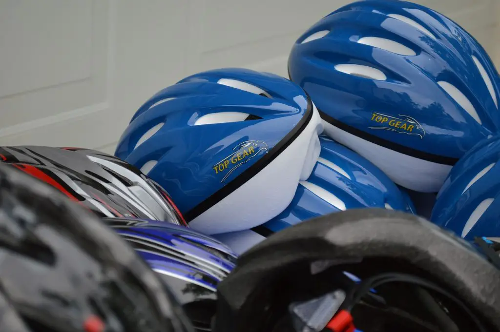 Image of stacked bicycle helmets with different color source pixabay