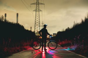 Image Of A Cyclist With Helmet Lights And Head Lights Source Unsplash