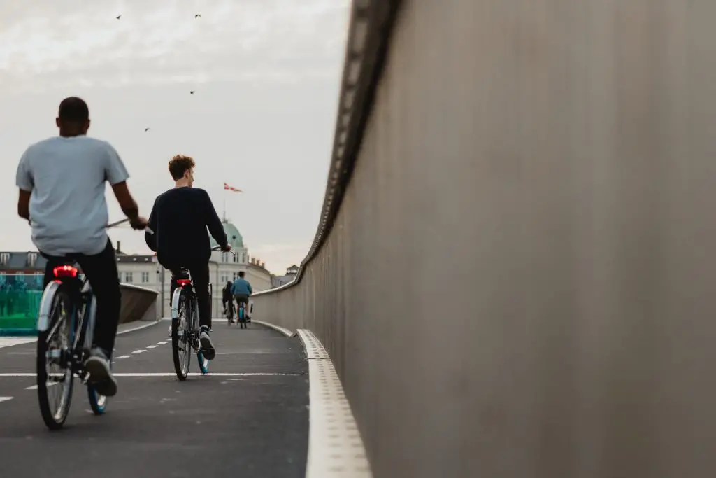 A group of cyclists riding on the side of the street. Source: unsplash