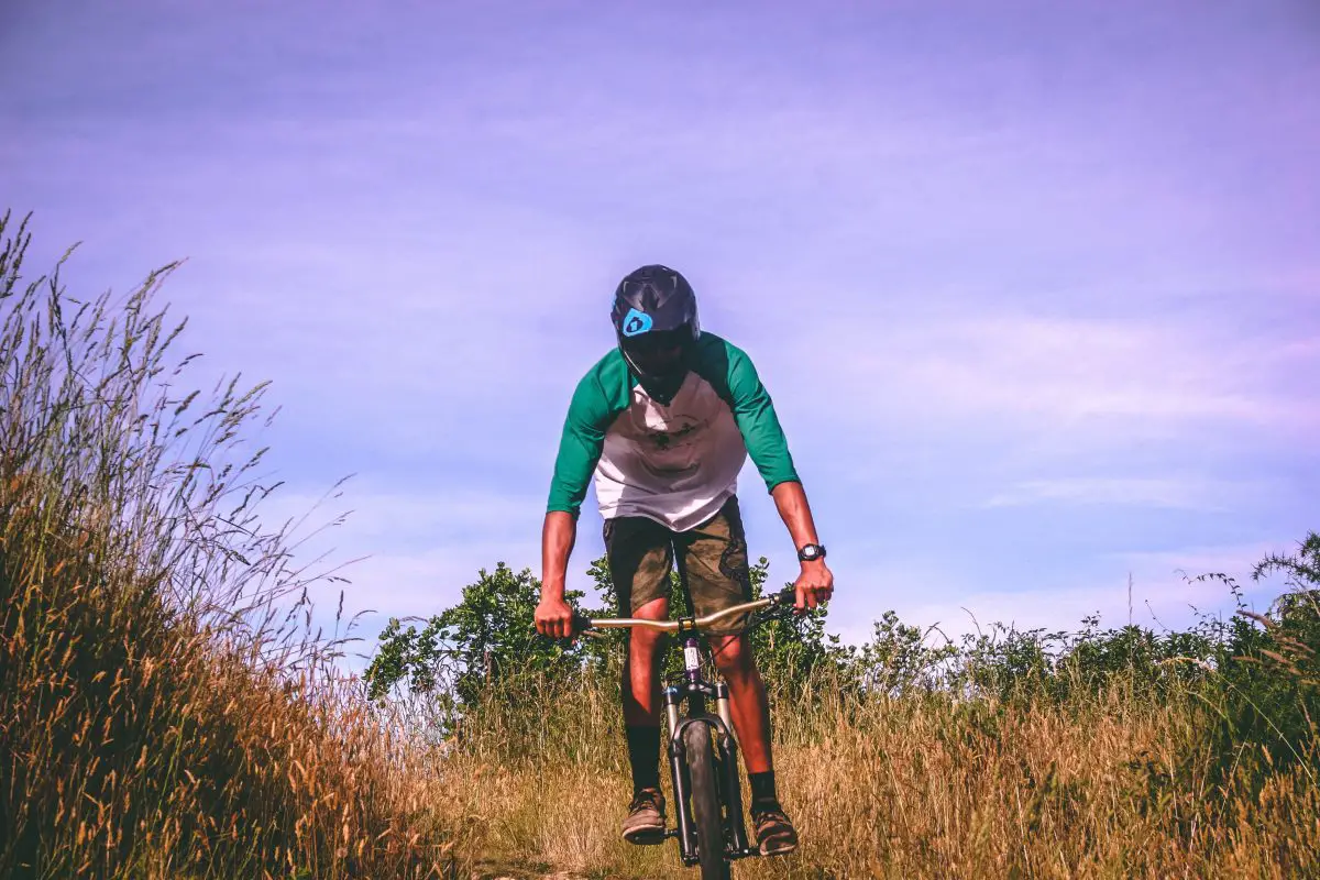 A man riding a bicycle on a terrain. Source: pexels
