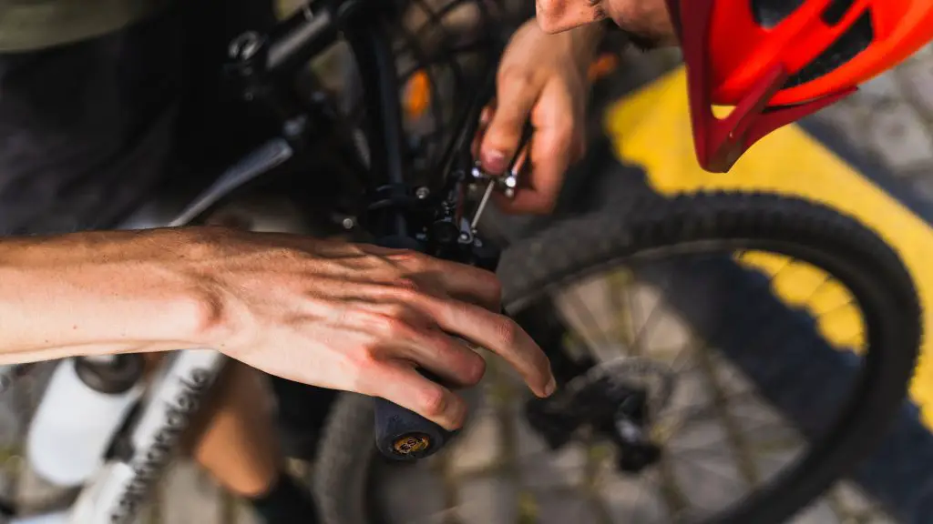 Closeup of a person fixing the handlebar on a bike. Source: pexels