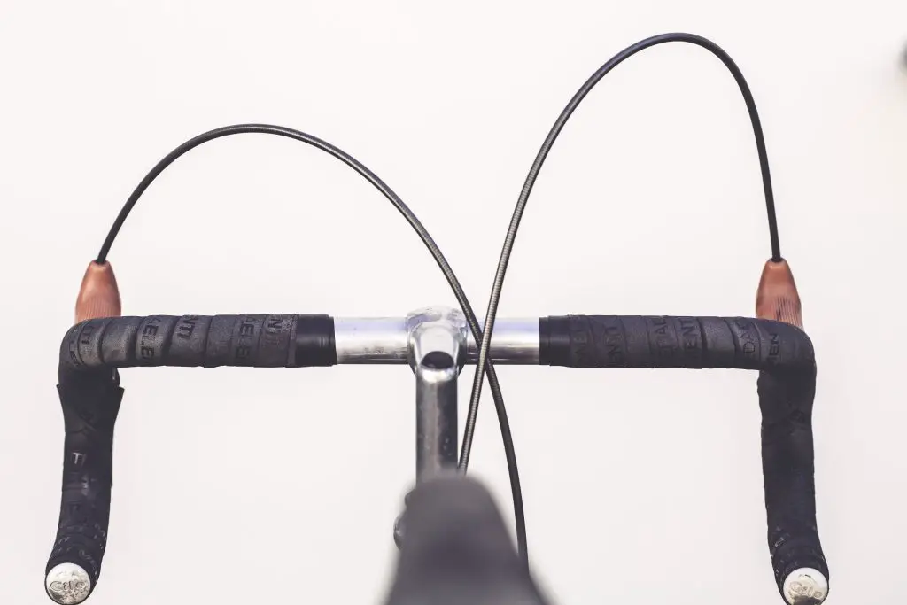Closeup of black bicycle handlebars. Source: Pexels